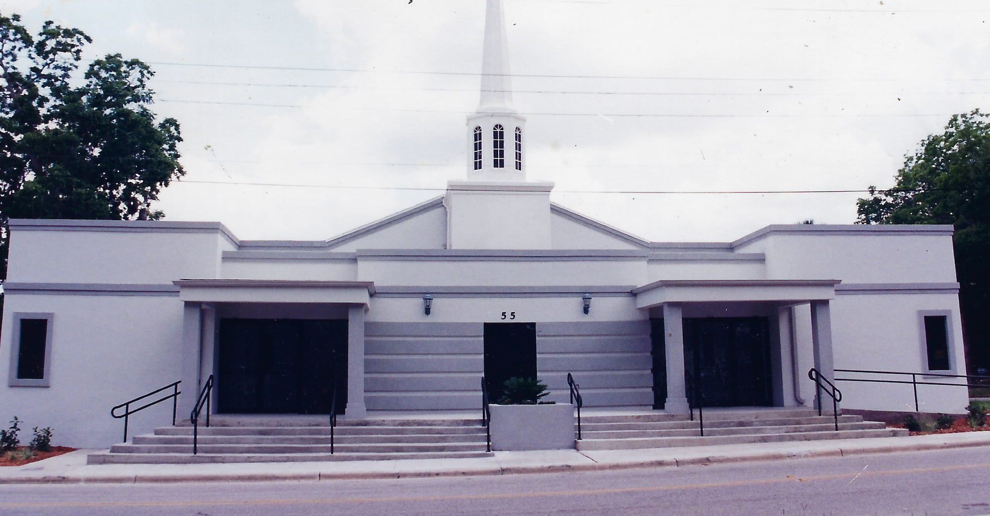 Two Person Standing Near White Church